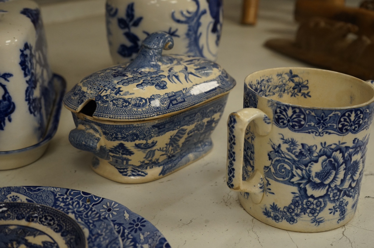 A group of blue and white ceramics to include Ironstone cheese dome and jug, a basin and twin handled cups, largest 36cm in diameter. Condition - varies